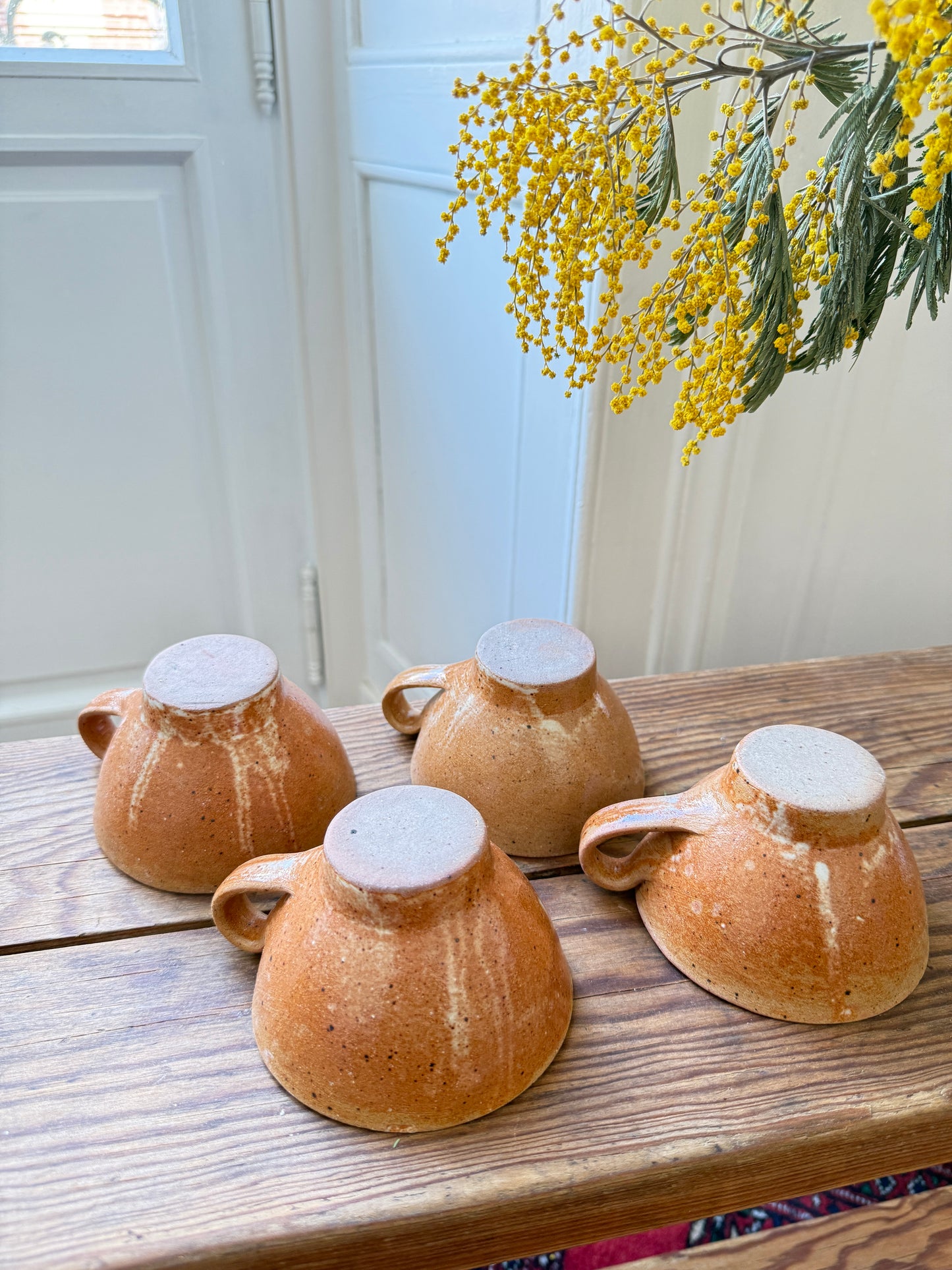 Set of four Razzia artisanal stoneware mugs with rustic, handcrafted design and natural earthy finish.