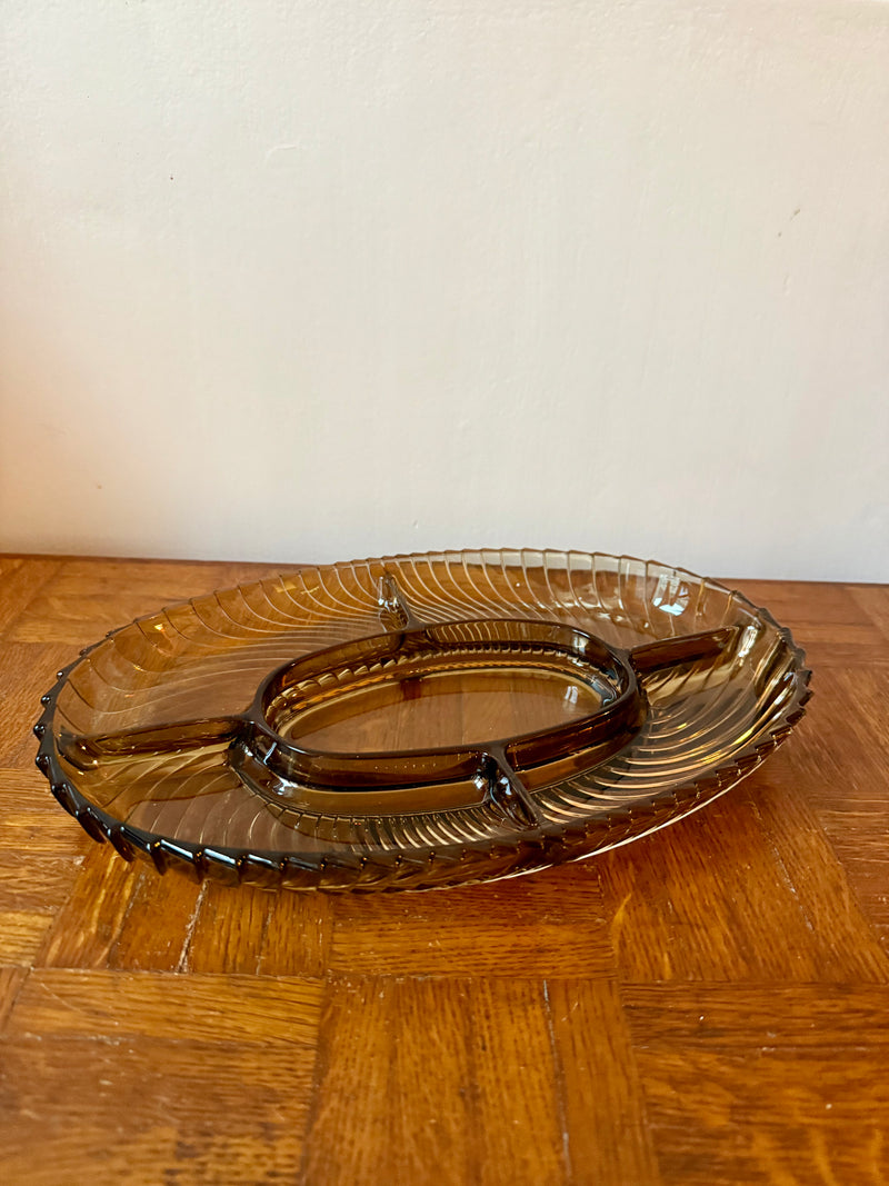 Fumed glass appetizer plate by Razzia Days showing a clear, smoked glass surface with elegant shape and smooth edges.