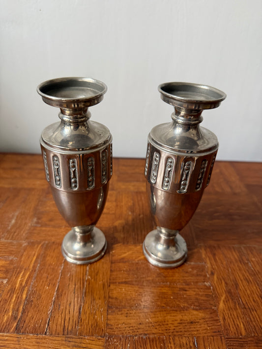 Pair of Art Deco silver metal vases with sleek, geometric design by Razzia Days on a neutral surface.