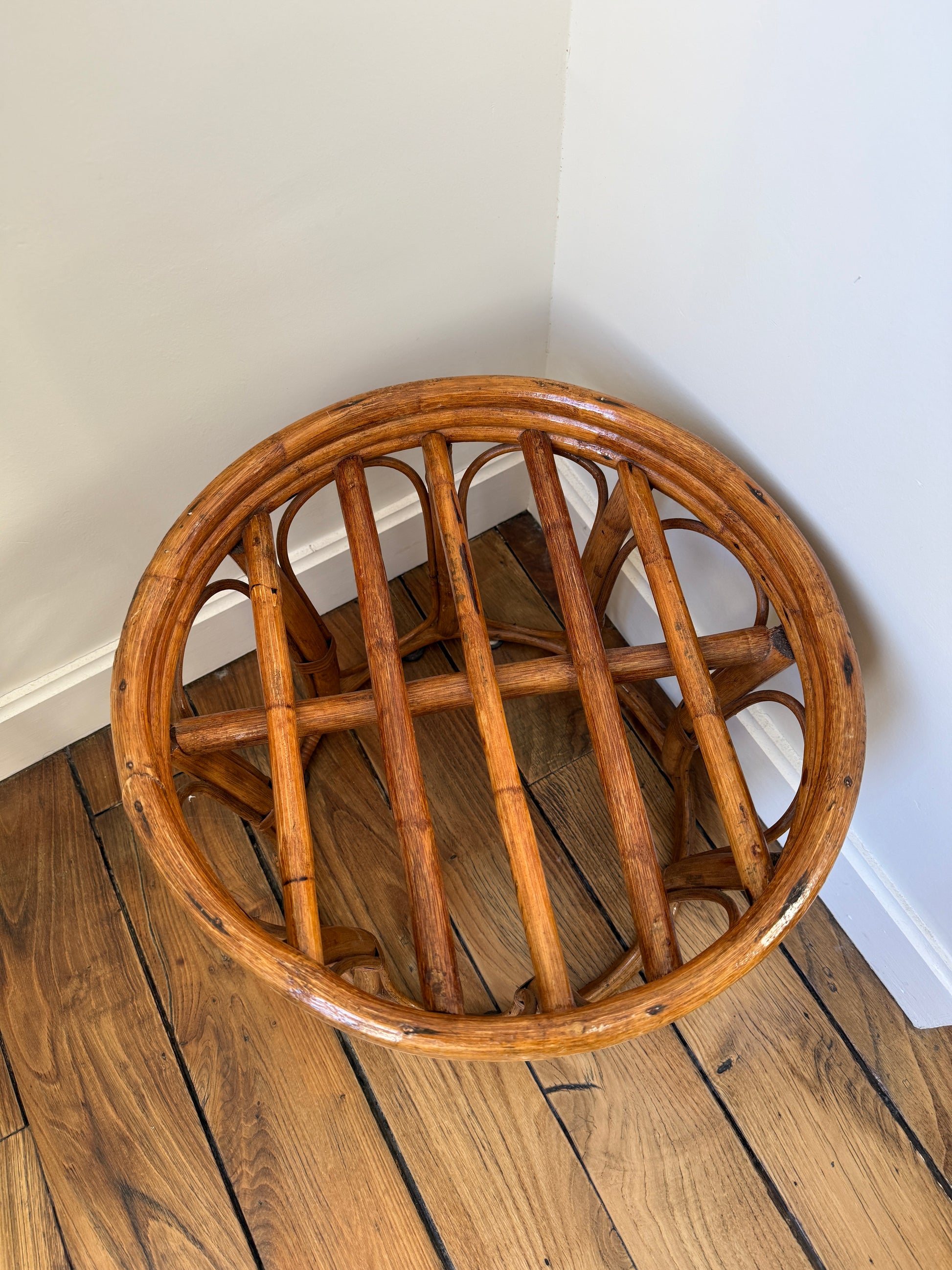 Vintage Razzia rattan stool with cushioned fabric seat, showcasing intricate weaving and cozy upholstery.