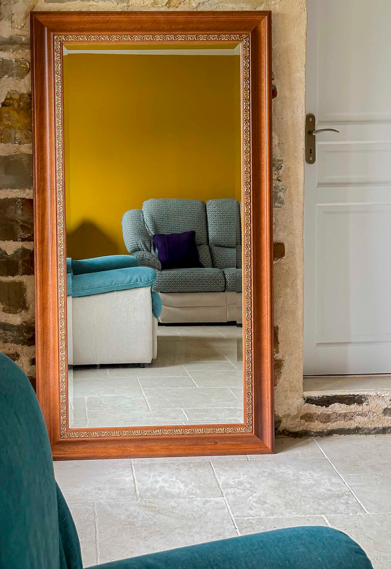 Elegant wooden framed gilded mirror with beveled edges, designed for standing placement, by Razzia.