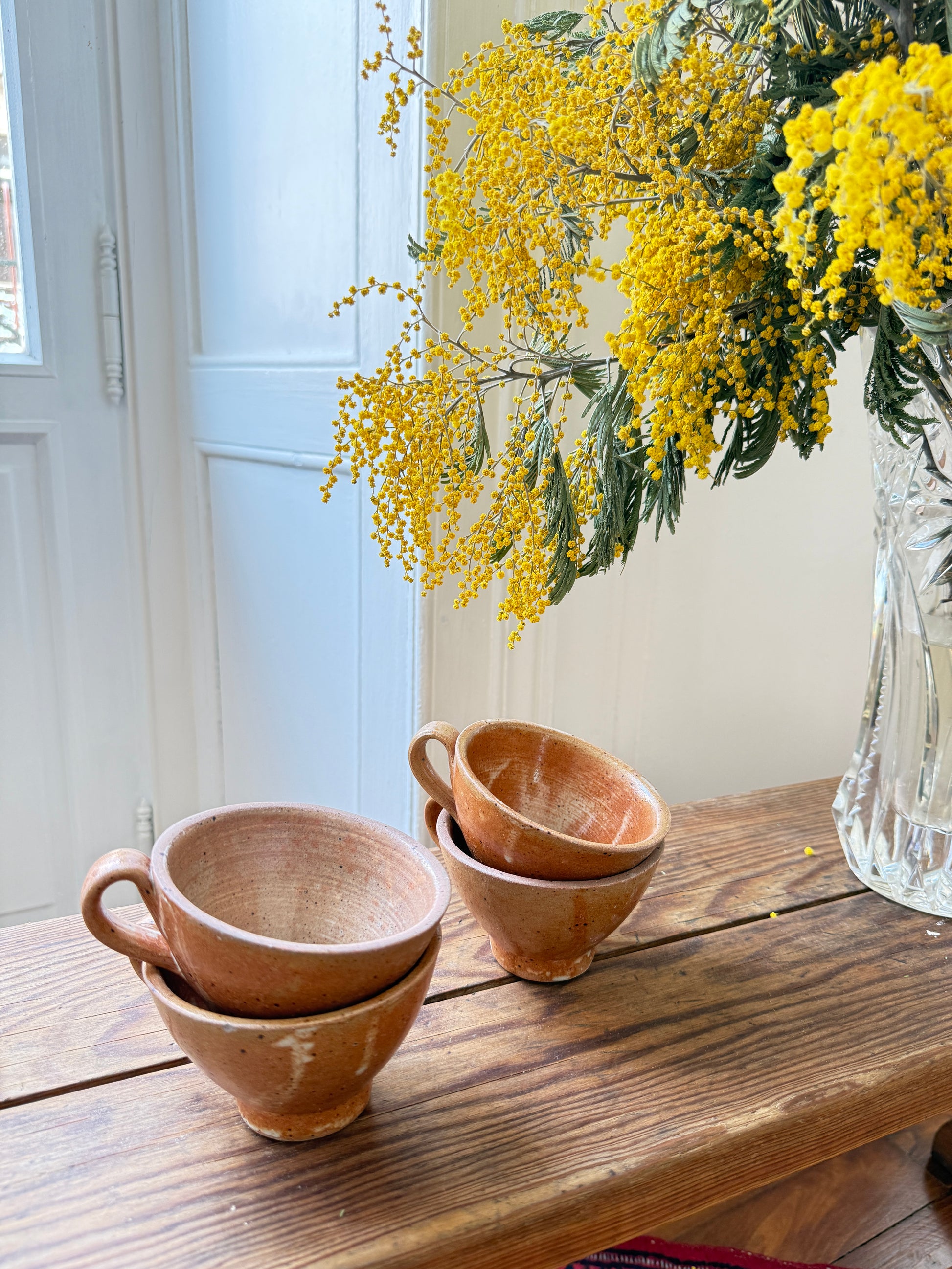 Set of four Razzia artisanal stoneware mugs with rustic, handcrafted design and textured glazed finish.