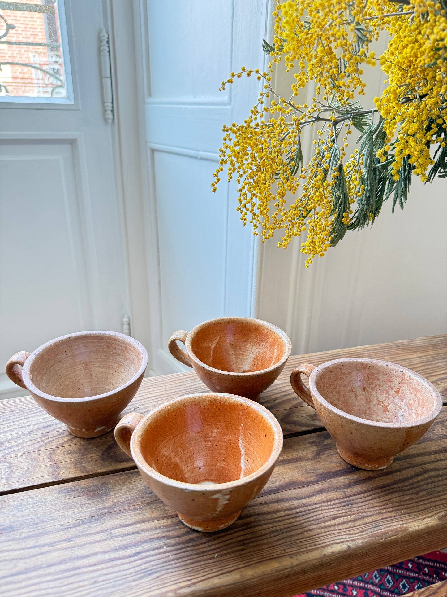 Set of four Razzia artisanal stoneware coffee cups with rustic glaze and handmade appearance.