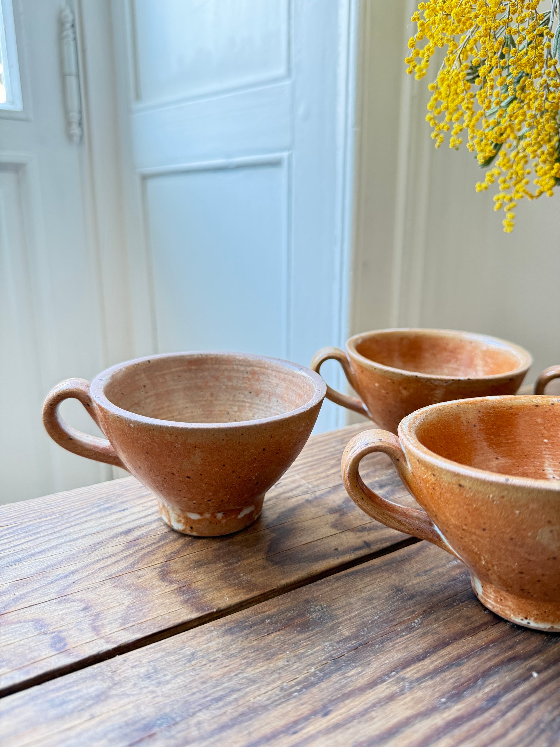 Set of 4 artisanal ceramic mugs by Razzia, showcasing rustic gray stoneware with handmade detailing.