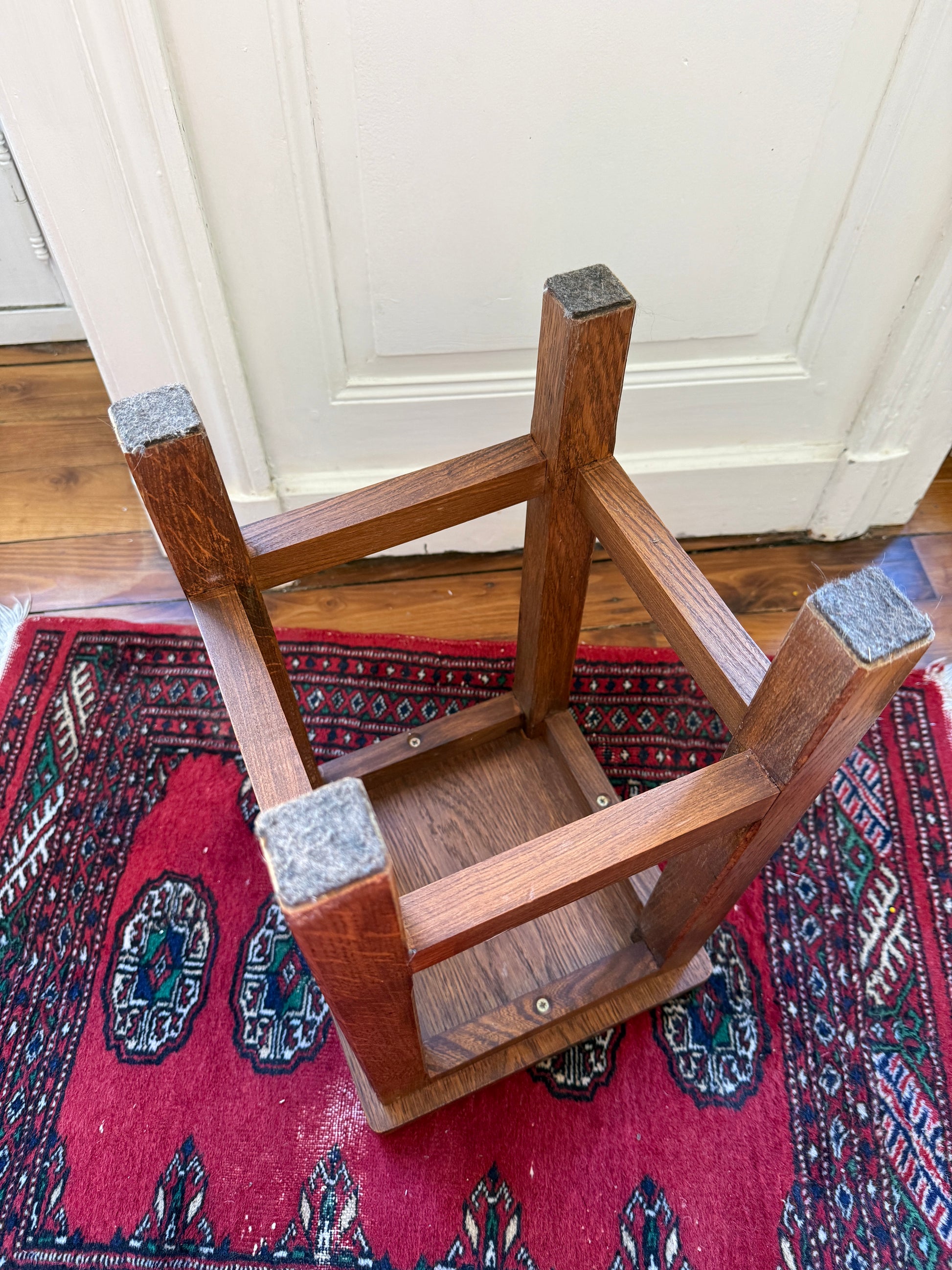 Brutalist wooden stool by Razzia with a minimalist design, featuring a solid wood seat and sturdy legs.