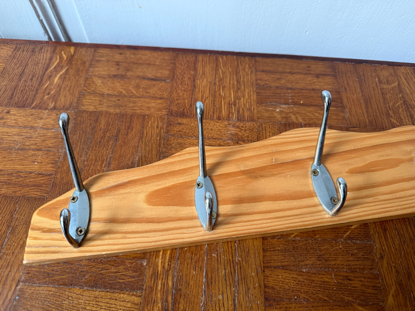 Wood and metal wall coat rack by Razzia with hooks and a modern design for hanging coats and accessories.