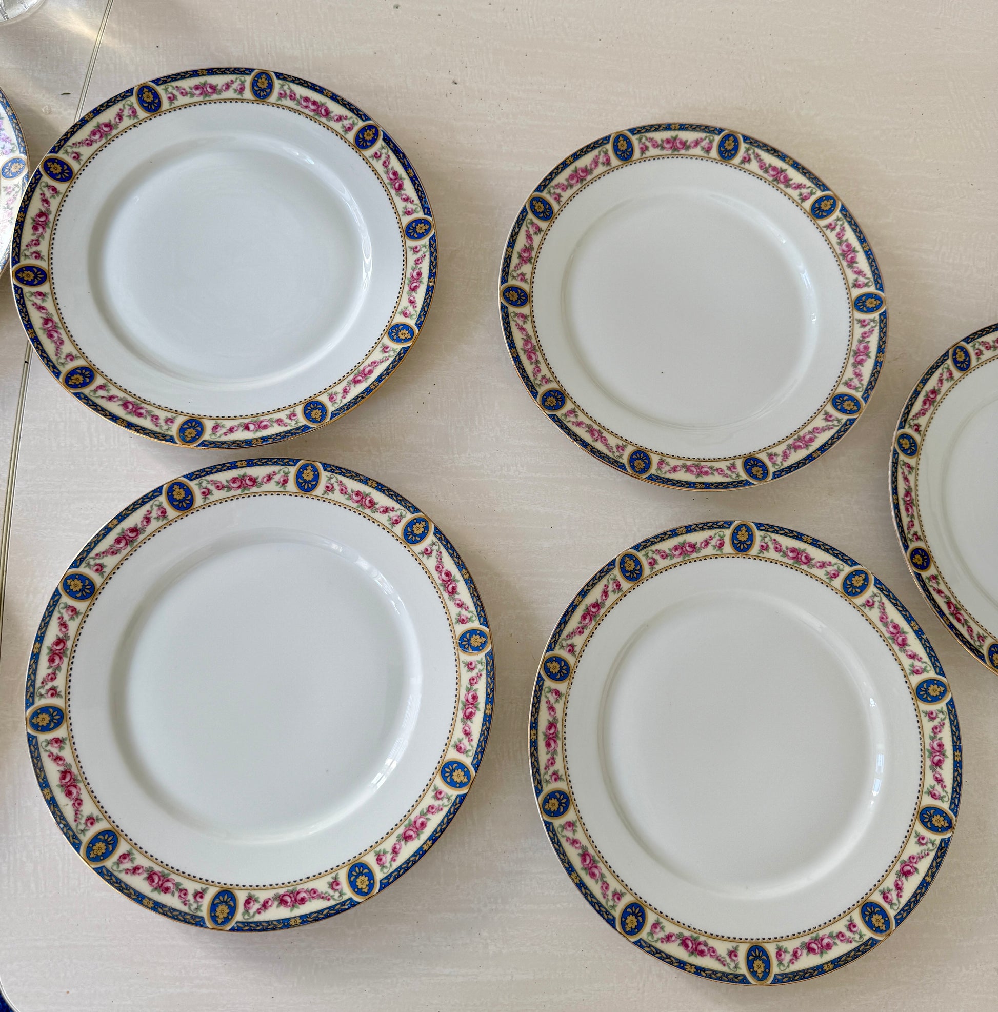 Set of 7 Razzia Limoges porcelain dinner plates with elegant white design and gold trim, perfect for formal table settings.