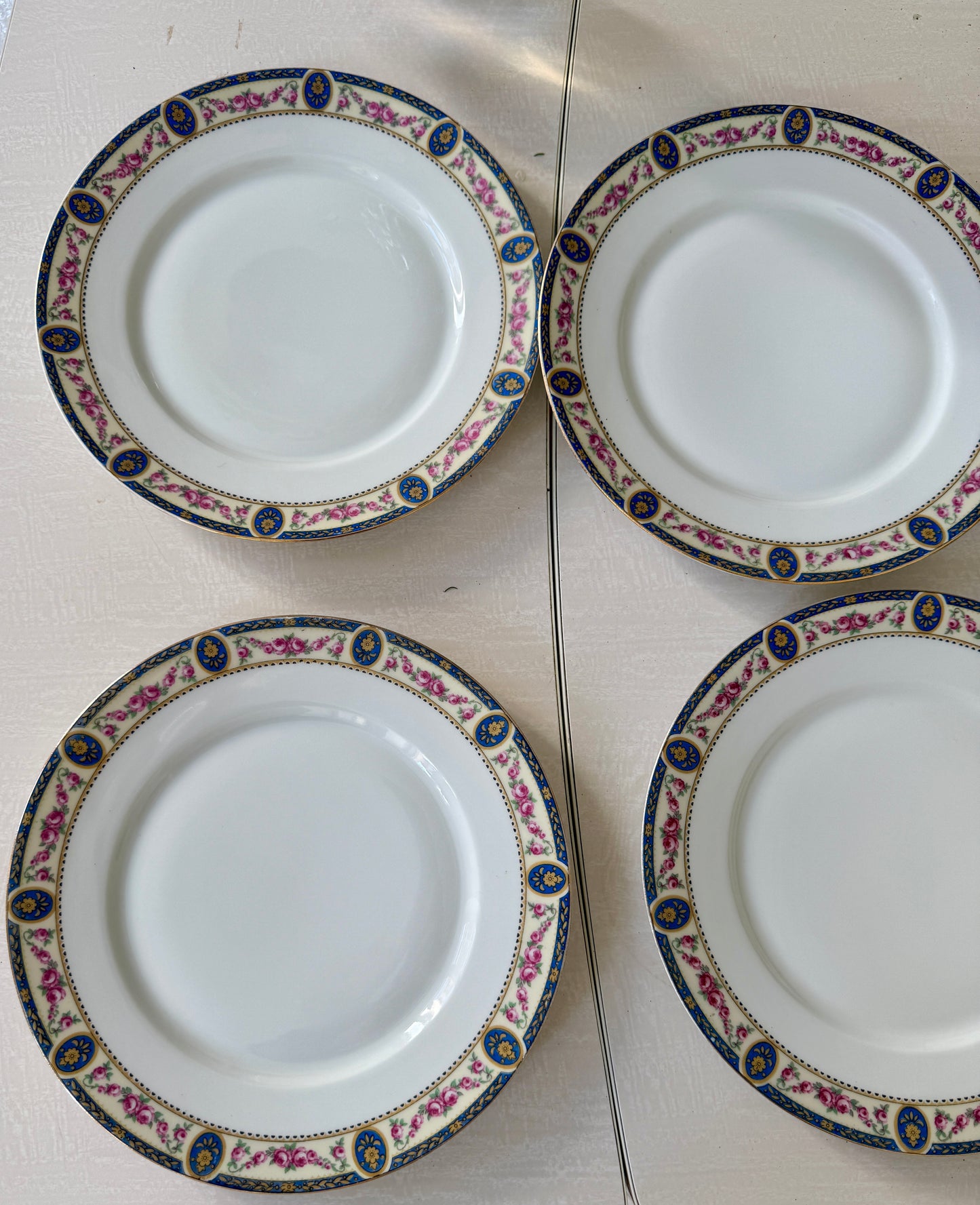 Set of 7 Razzia Limoges porcelain dinner plates with elegant white design, perfect for formal dining.