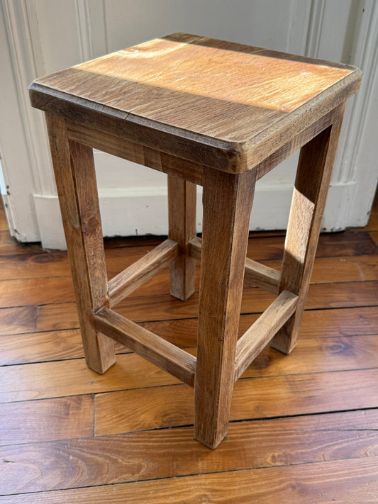 Brutalist wooden stool by Razzia with aged, distressed finish and natural wood texture, showcasing a rustic, industrial design.