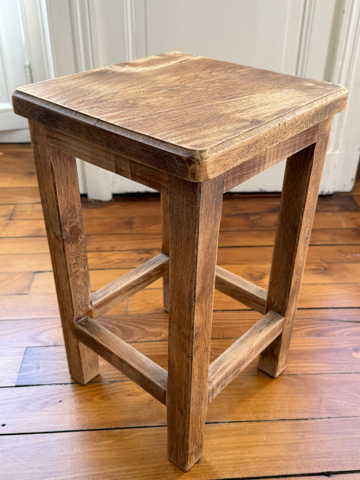 Razzia brutalist wooden stool with distressed, aged finish, showcasing a rustic, natural wood design and sturdy construction.