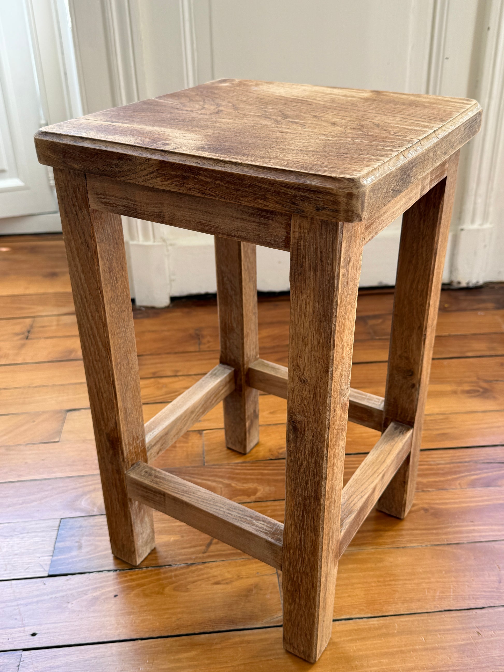 Brutalist wooden stool with distressed, aged finish by Razzia, showcasing a rustic, natural wood design.