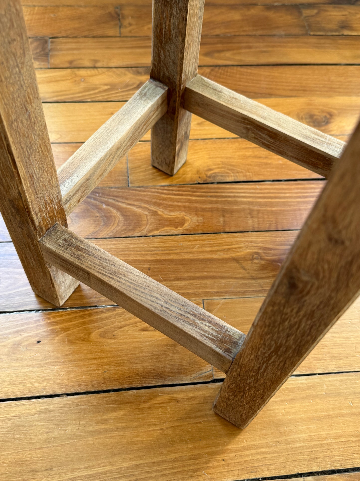 Razzia brutalist wooden stool with distressed aged finish, showcasing a rustic, natural wood surface and sturdy design.