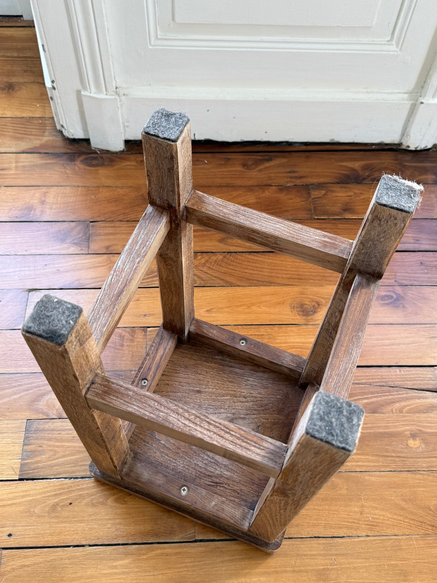 Brutalist wooden stool with distressed, aged finish by Razzia, showcasing a natural, rustic design perfect for modern interiors.