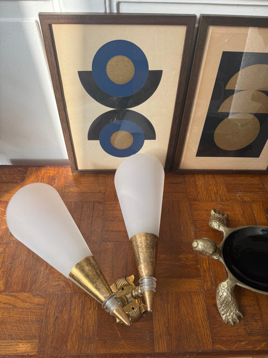 Razzia brass and plastic wall applique light fixture with modern design, mounted on a wall with a sleek, contemporary aesthetic.