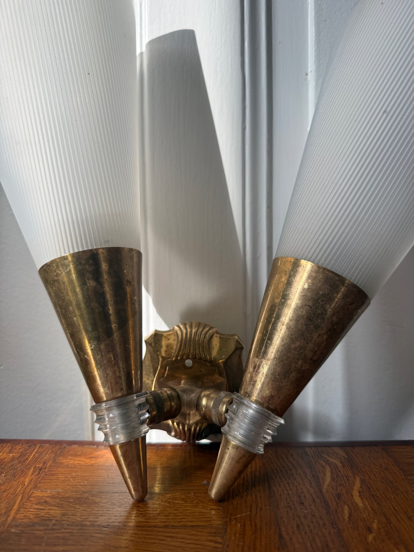 Razzia brass and plastic wall applique with modern design, featuring a sleek gold finish and minimalist style.
