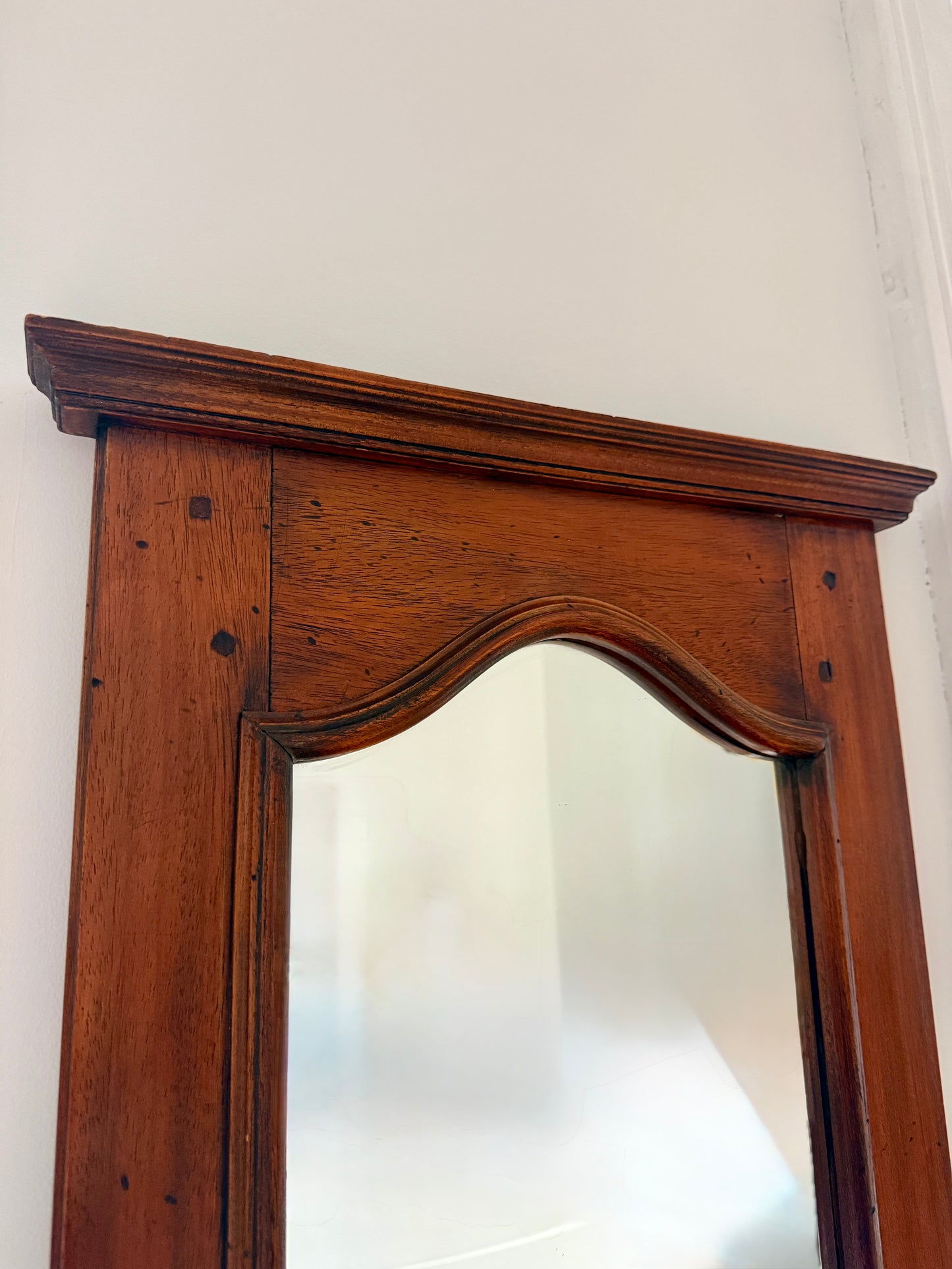 Miroir de toilette ancien en bois Razzia, style classique avec cadre en bois sculpté et reflet visible.