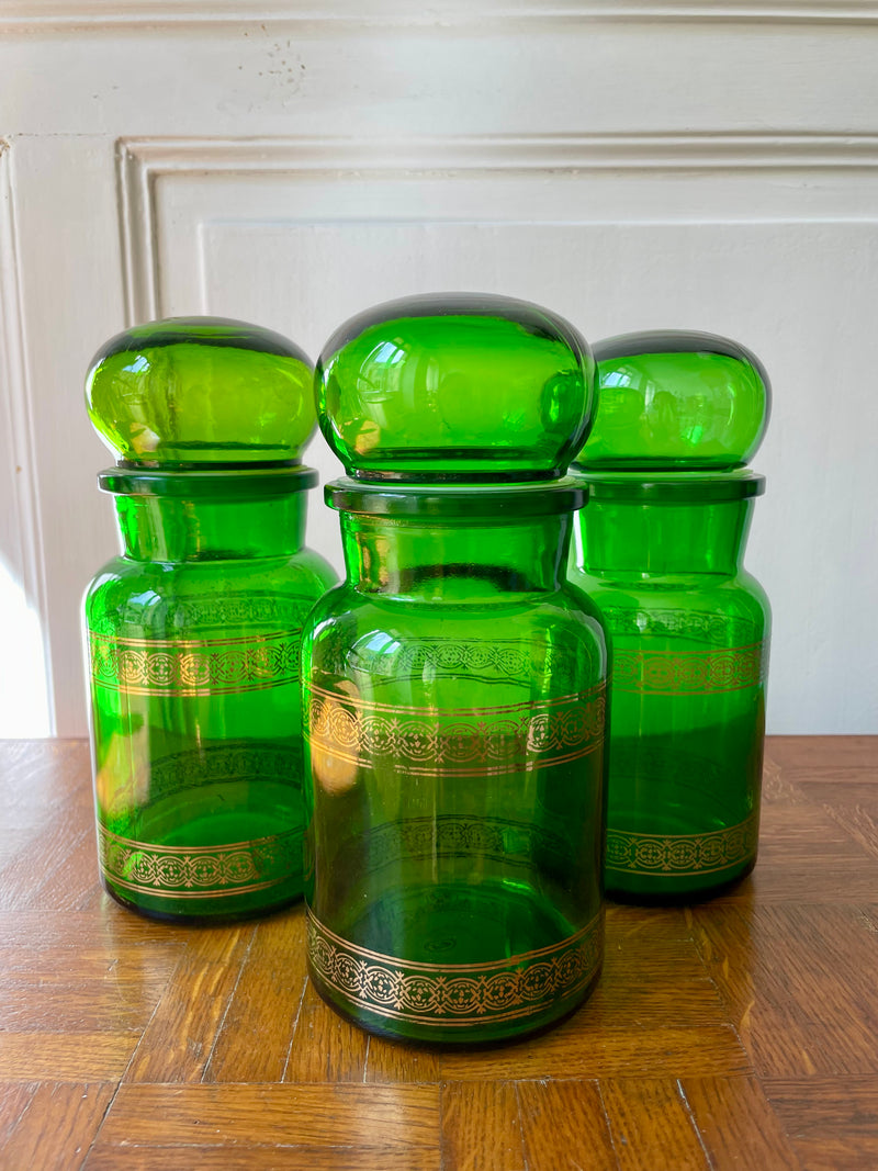 Green glass apothecary bottle from Razzia Days with a vintage-style design.