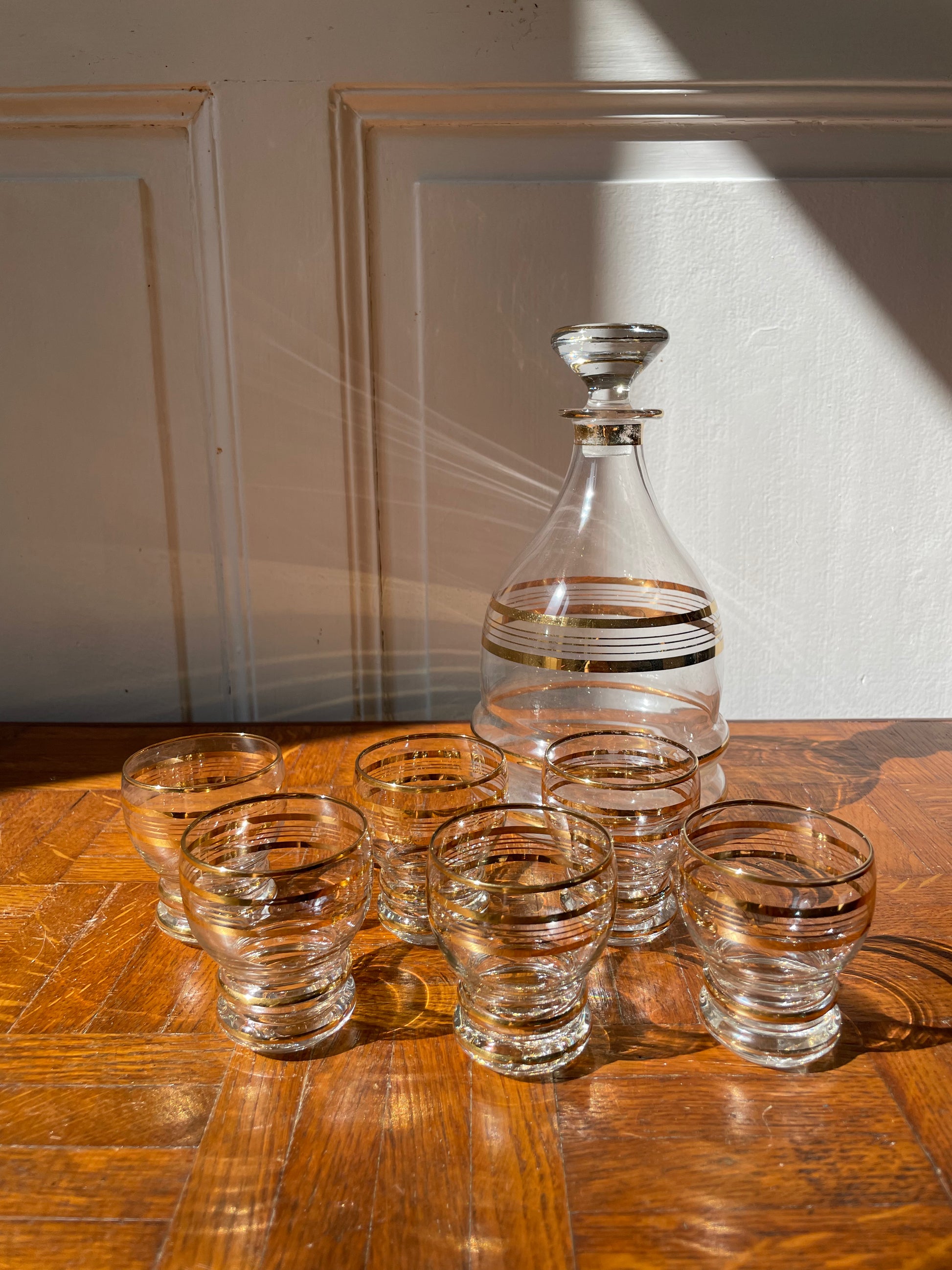 Vintage Razzia Days carafe and liqueur glasses set with clear glass and intricate design, ideal for serving spirits.