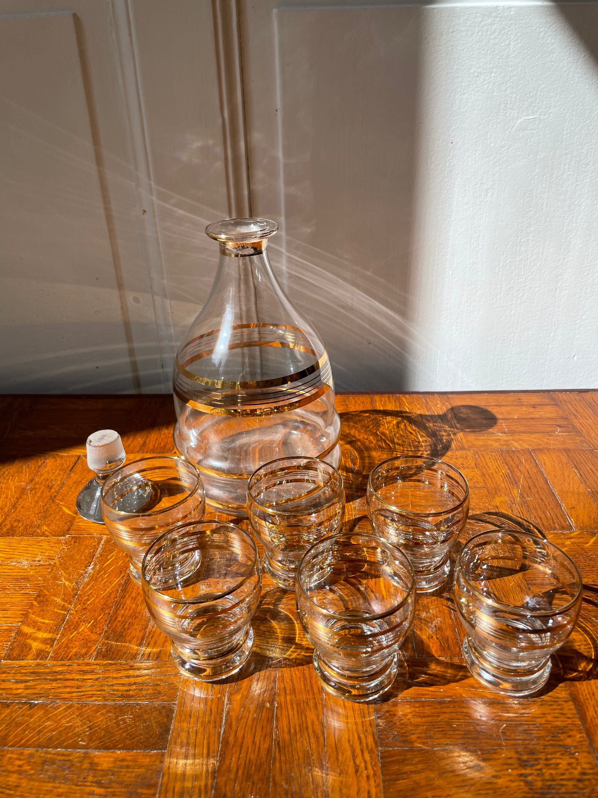 Vintage Razzia Days carafe and liqueur glasses set with clear glass and intricate design, perfect for serving spirits.