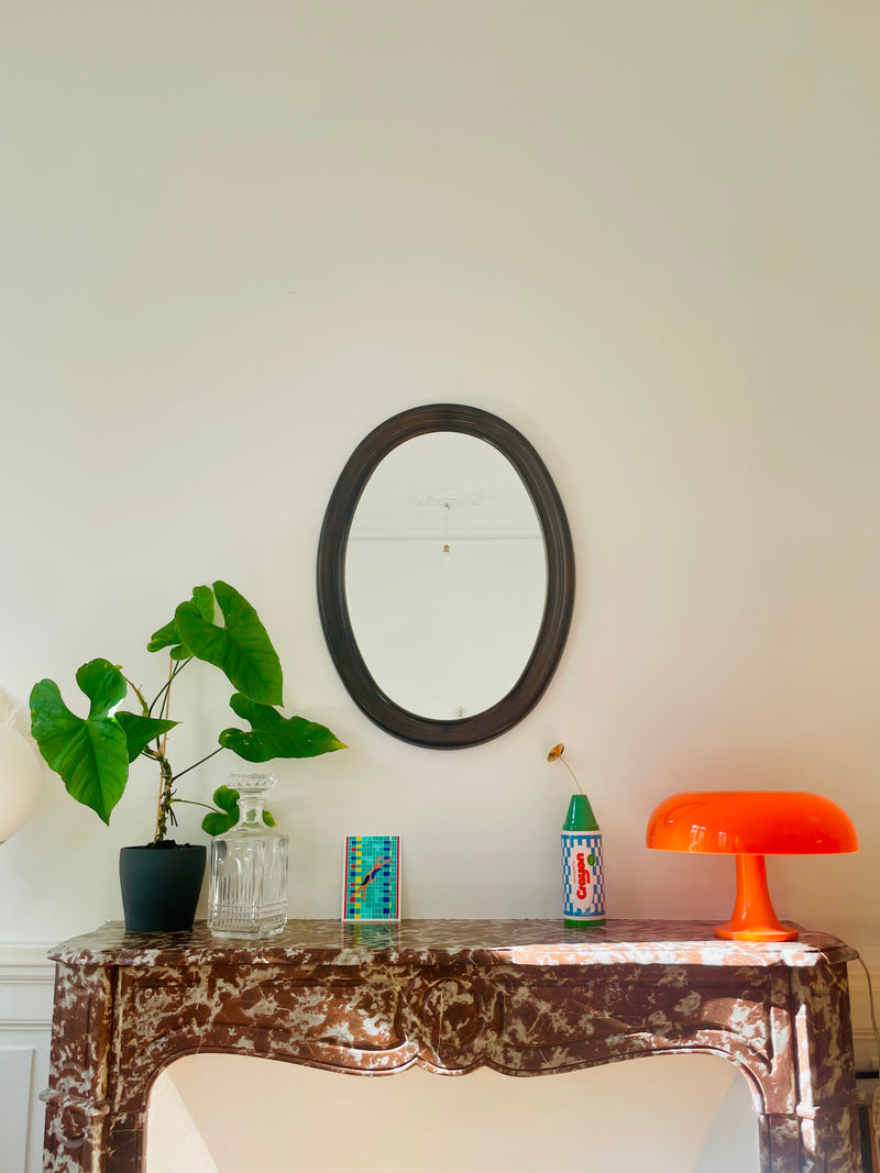 Vintage oval mirror by Razzia Days with a classic frame, showcasing a reflective glass surface and elegant design.