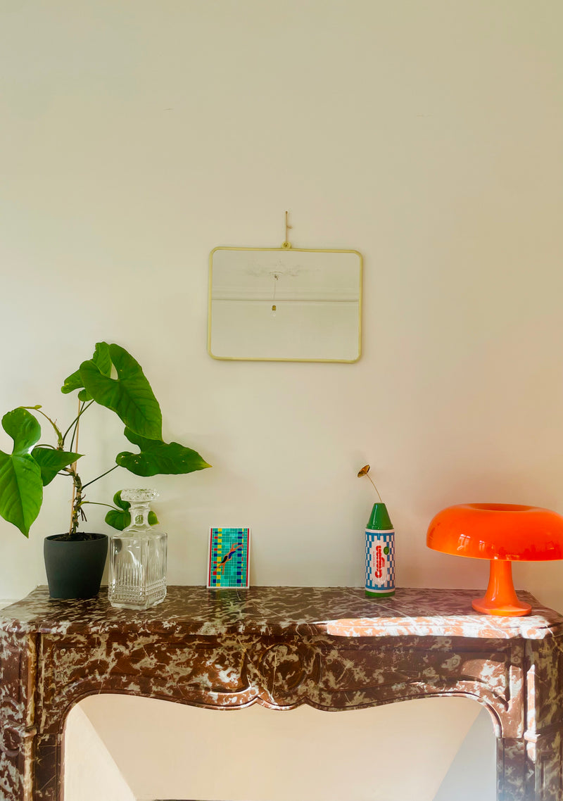 Vintage yellow barber mirror by Razzia Days with a classic design, reflecting the surrounding space in the image.